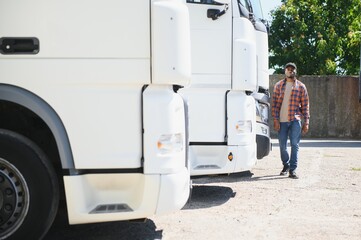 Professional truck driver Standing in front of the semi truck.