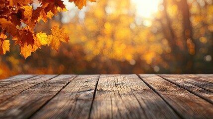 Fototapeta premium An empty wooden table top in the foreground, with a blurred background of golden autumn maple leaves, perfect for showcasing seasonal products or designs.