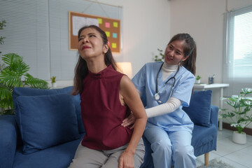 Fototapeta premium Female doctor giving advice Ask elderly patients about their medical history. Talk about waist pain, arm pain, coughing, sneezing, stomach pain and fever, blood pressure measurement, treatment ideas.