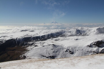Majestic snow-capped mountain range under clear blue sky, a breathtaking winter wonderland
