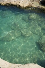 Clearly visible sea bottom of the mediterranean coast with turquoise water