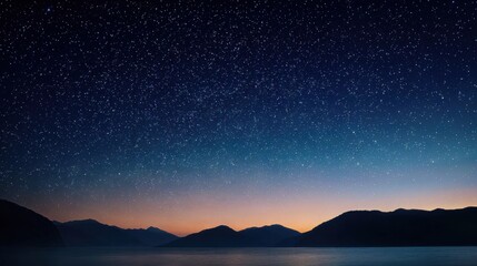 Dark mountain range silhouette under starry night sky