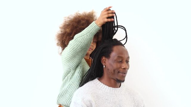 Adorable black girl in crown combing her dad hair