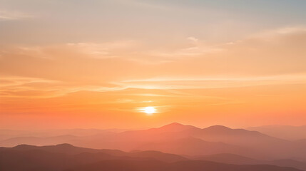 Fototapeta premium Silhouettes of Mountain Ranges with a Hazy Sunset