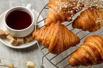 Tea with croissants on a light table. Sweet breakfast