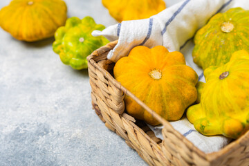 Pattypan zucchini on a textured kitchen table. squash. Fresh organic pattypan squashes on...