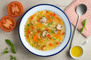 Short noodle soup with vegetables and mushrooms. Top view table with  decoration.
