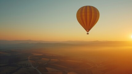 Fototapeta premium Hot Air Balloon Soaring Over Golden Hour Landscape