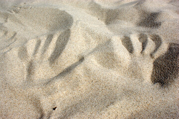 Sand on desert beach close-up handprint