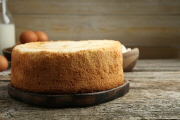 Tasty fresh sponge cake on wooden table