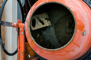 Concrete mixer mixing cement, sand and water to produce concrete