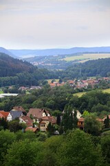 Village of Suhl, Germany nestled in valley with scattered houses surrounded by lush greenery and hills