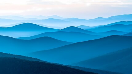 Fototapeta premium Serene blue mountain landscape with rolling hills and soft mist.