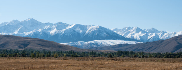 Panoramic shot of rocky peaks of mountain range in Kyrgyzstan