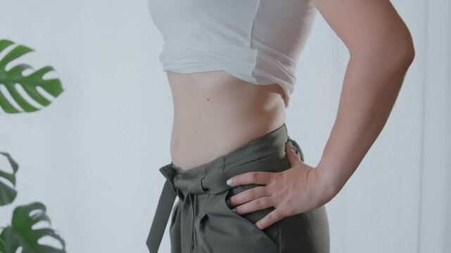 Young female suck in your stomach to seem slim