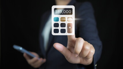 Businessman pointing finger at calculator Calculating income and expenses family financial account for step up growing  Saving money for future plan and retirement fund concept.