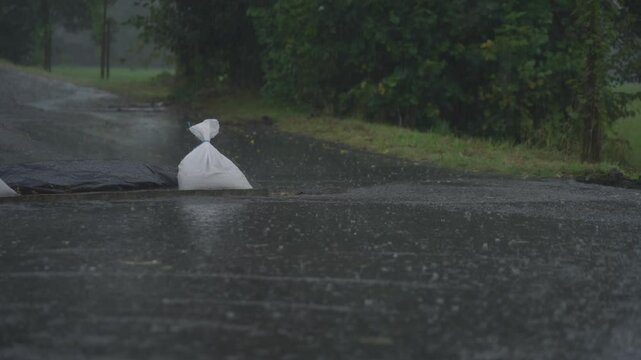 Pan Closer Static shot of rain and bags of sand