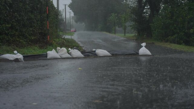 Closer Static shot of rain and bags of sand