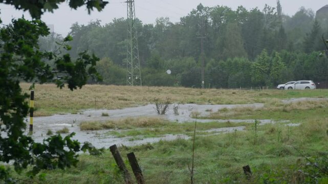 Two cars standing in the flooded field