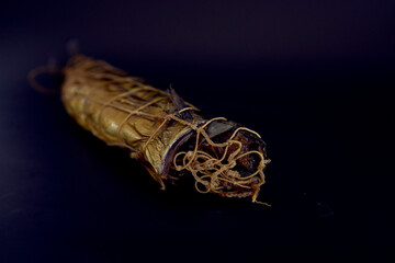 Appetizing hot smoked golden mackerel on a black background