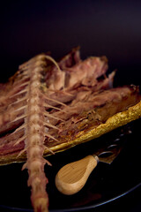 the  process of dissecting hot smoked golden horse mackerel with small knives