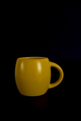  large yellow cup on a black background
