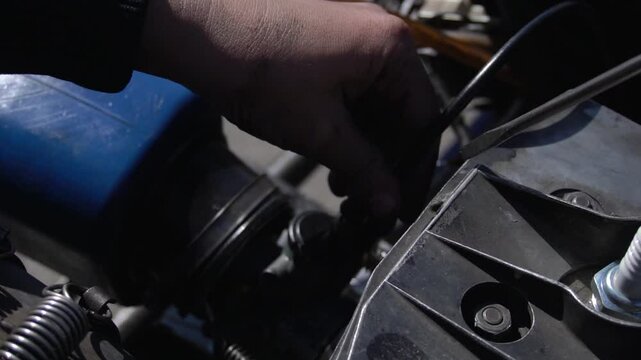 close-up of the engine cover of a racing car. A mechanic fixes the throttle. Race car service
