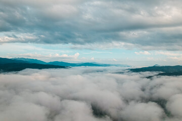 Fototapeta premium Aerial view of fog and morning sky from drone