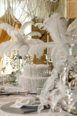 white table decorated with down, pearls, ribbons, prepared for a wedding ceremony, New Year's table
