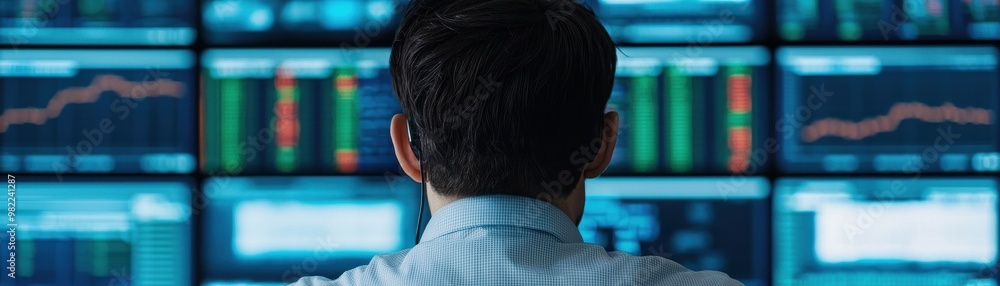 Poster a professional analyzing stock market data displayed on multiple screens in a modern office environm