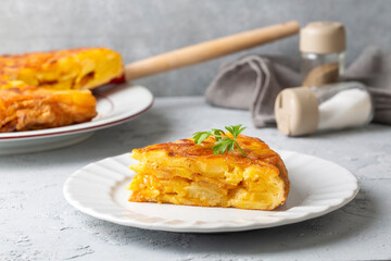 Spanish omelette with potatoes, typical spanish cuisine on gray concrete floor. Tortilla Espanola. Turkish name; Yumurtali patates