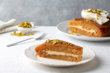 Sherbet bread kadayif dessert. Turkish Ramadan dessert. Bread kadayif dessert with cream on a marble serving plate. Local name kaymakli ekmek kadayifi