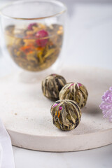 Exotic Handcrafted Flower Tea Balls with exquisite Infusion . Asian green tea ceremony. Vertical