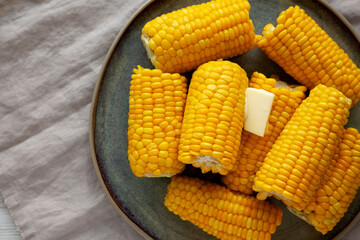 Homemade Organic Steamed Yellow Sweet Corn on the Cob with Butter, top view.