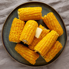 Homemade Organic Steamed Yellow Sweet Corn on the Cob with Butter, top view.