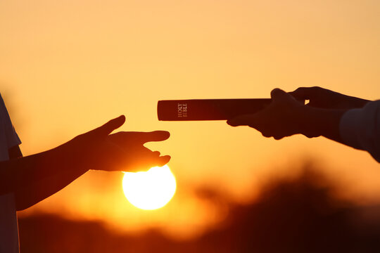 Christian giving the Holy Bible as a gift, church evangelism concept that spreads the gospel and love of Jesus Christ
