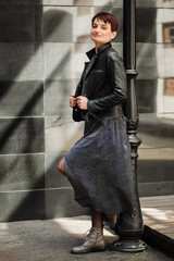 Young brunette woman in casual clothes stand on the street posing