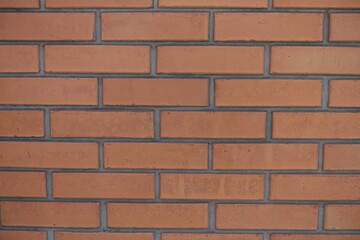 Fototapeta premium Close shot of red smooth brick wall with standard stretcher bond