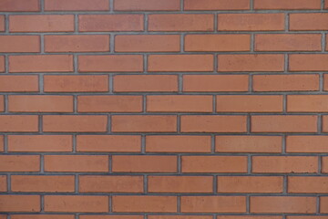 Texture of red smooth brick wall with standard stretcher bond