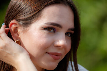 Fototapeta premium Portrait of a brunette girl outdoors in summer