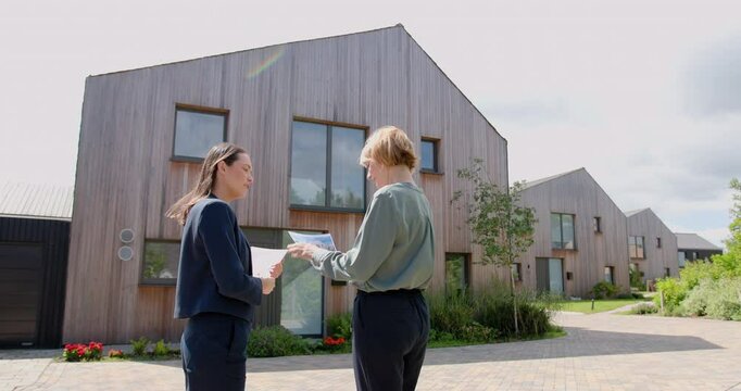 Real estate agent Showing a Property to a mature Woman and Handshake