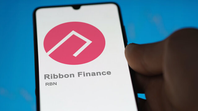 Close up on logo of (RBN) Ribbon Finance on the screen of an exchange. (RBN) Ribbon Finance price stocks, $RBN on a device.