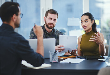 Creative, business people and team discussion with paperwork in meeting for brand or target...