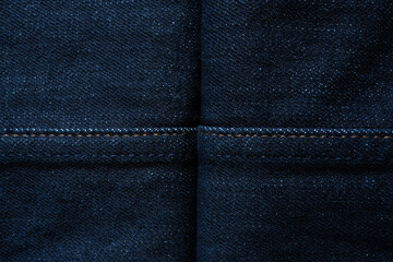 Naklejka premium Dark blue denim jeans texture background with cross lines