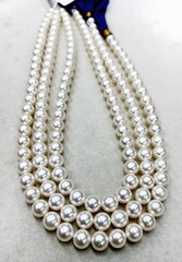 Elegant Three-Strand Pearl Necklace Displayed Neatly