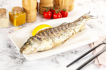 Grilled sea bass fish served lemon