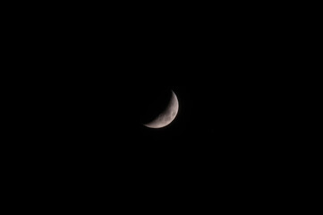 A high-resolution image of an white crescent moon against a dark sky. The moon is crisp and detailed, making it perfect for compositing.