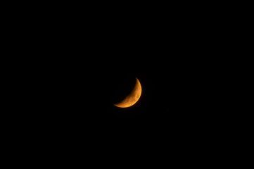 A high-resolution image of an yellow crescent moon against a dark sky. The moon is crisp and detailed, making it perfect for compositing.