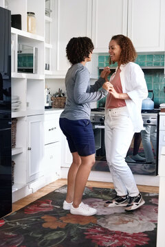 Couple holding hands in kitchen