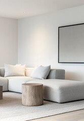Modern minimalist living room with gray sectional sofa and wooden accent table in bright, natural light